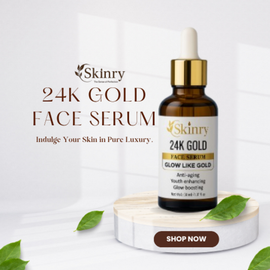 Skinry 24K Gold Face Serum bottle with dropper on a white marble platform with green leaves